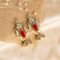 Crimson Charm Gold-Plated Pearl Fringe Jhumkas